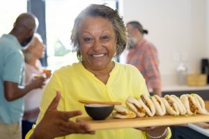 Senior Lady About to Enjoy Boa Buns with Furniture for Assisted Living Facilities